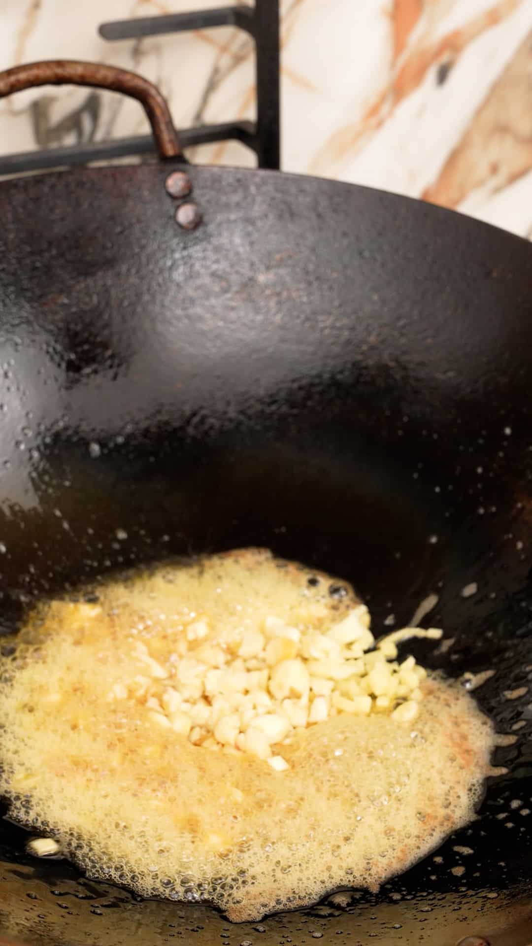 Cooking butter with garlic in a wok.