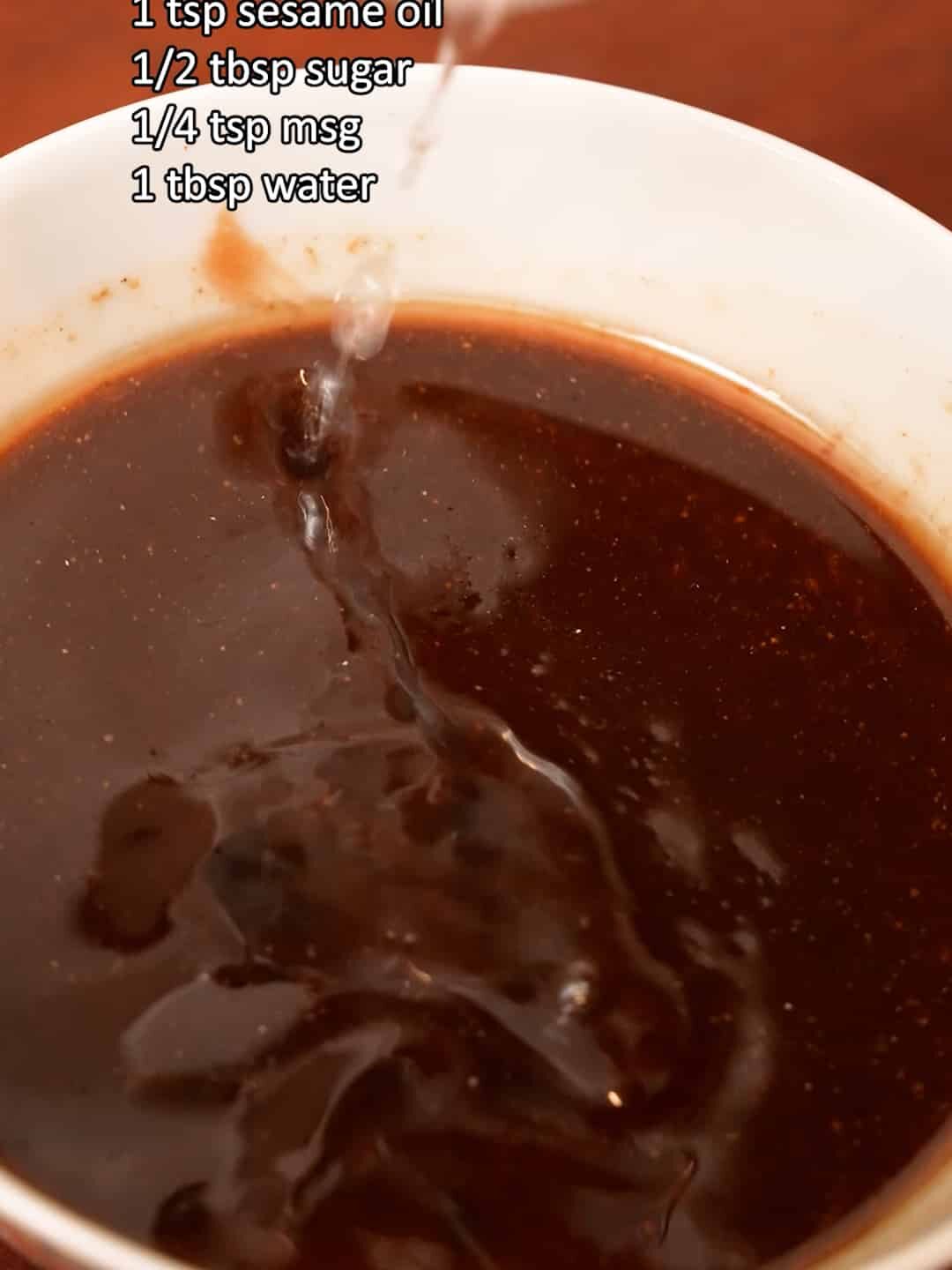 Mixing the sauce for garlic shrimp noodles in a bowl.