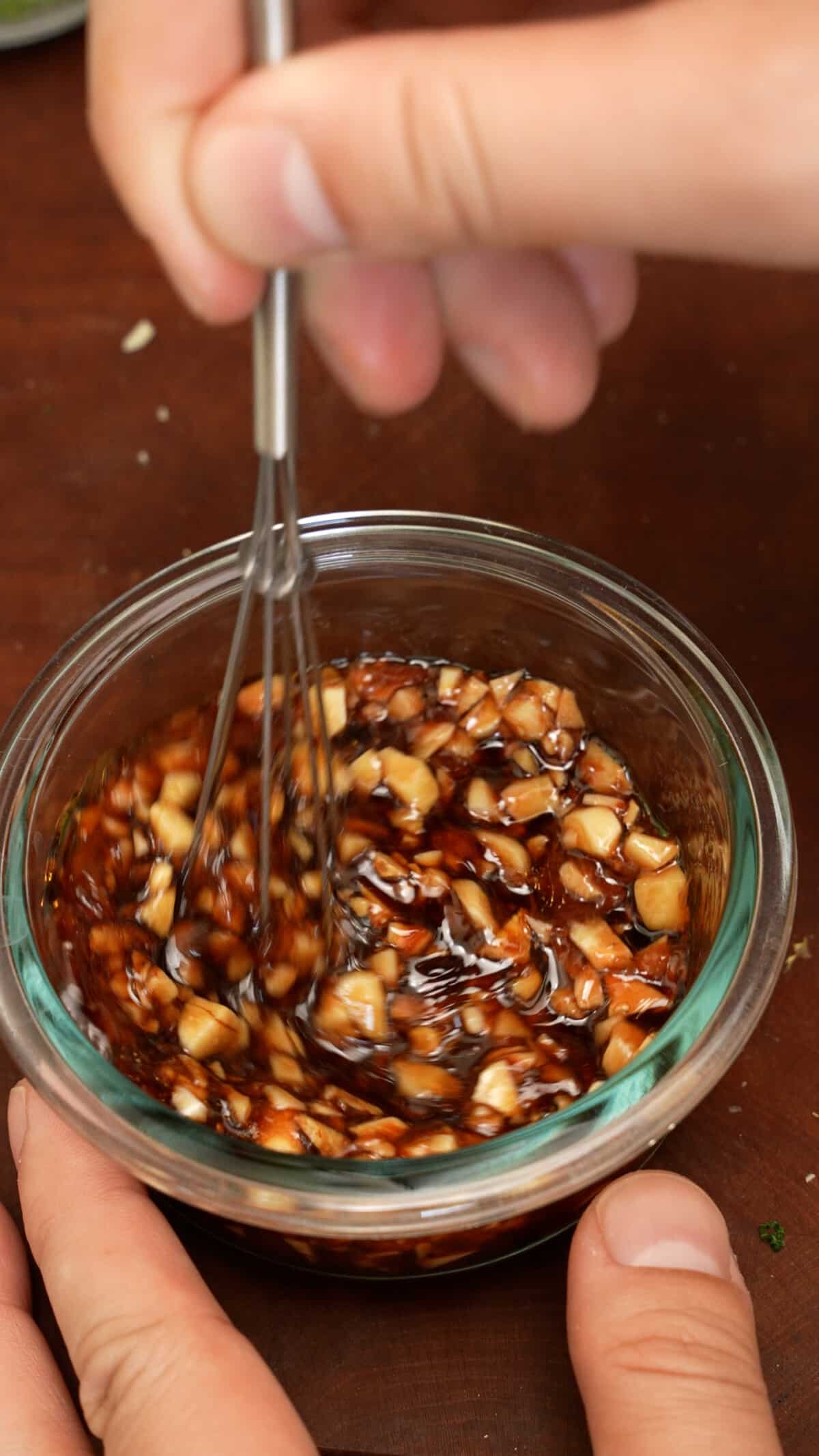 Mixing the honey garlic sauce for the chicken in a bowl.