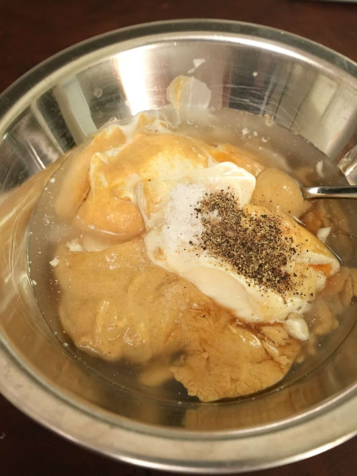 Raw ingredients for honey mustard in a bowl.