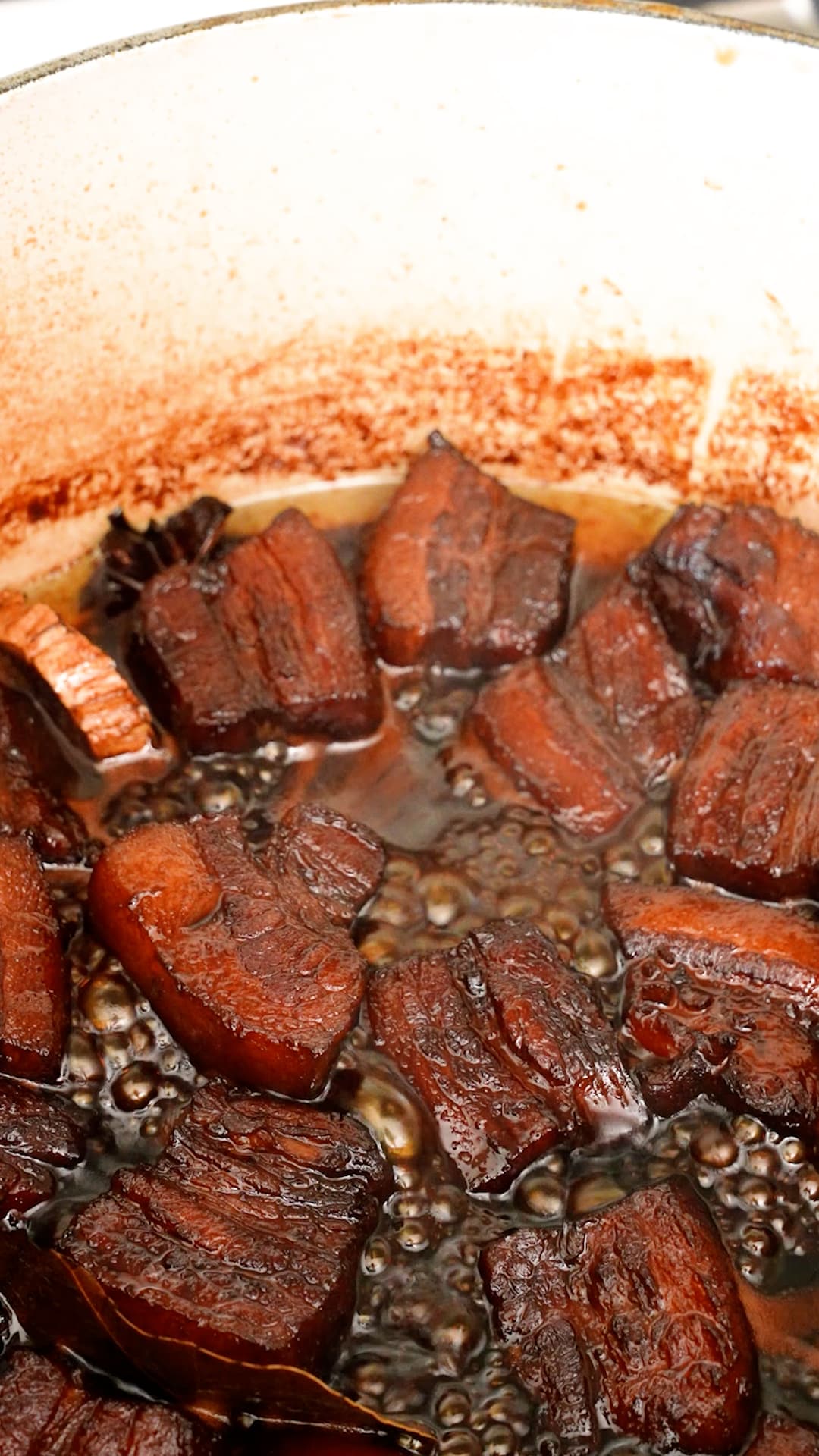 Pork belly simmering in a pot.