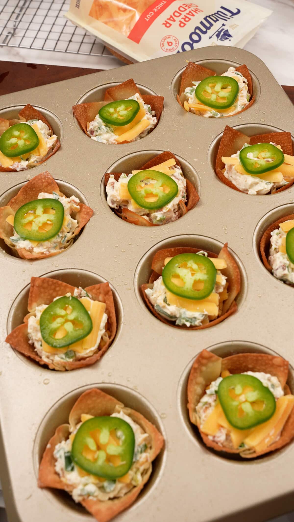 Jalapeno Popper Wonton Cups in a nonstick muffin tin.