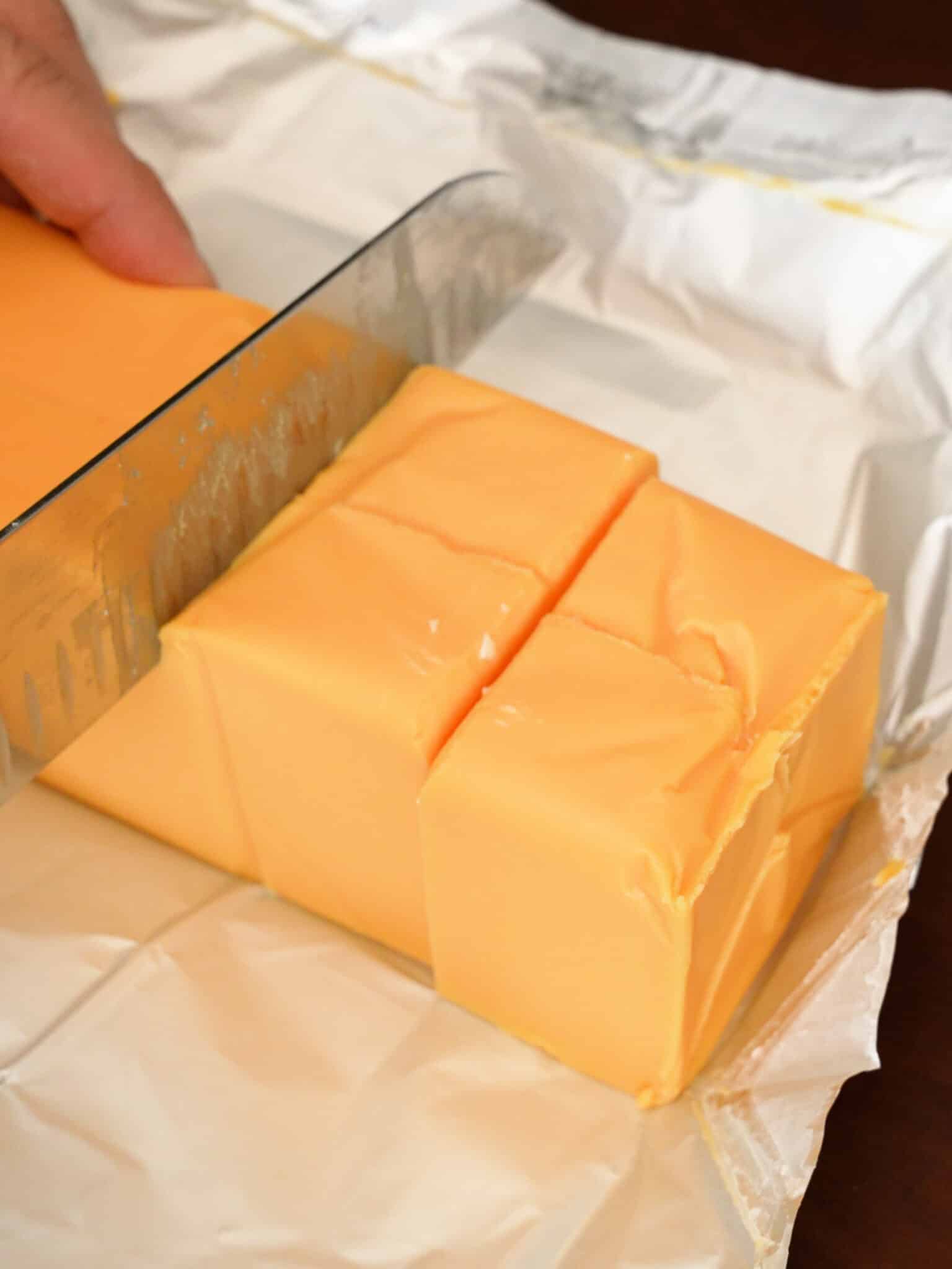 A knife cutting Velveeta cheese.