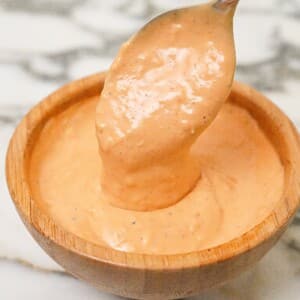 Homemade spicy mayo in a bowl with a spoon.