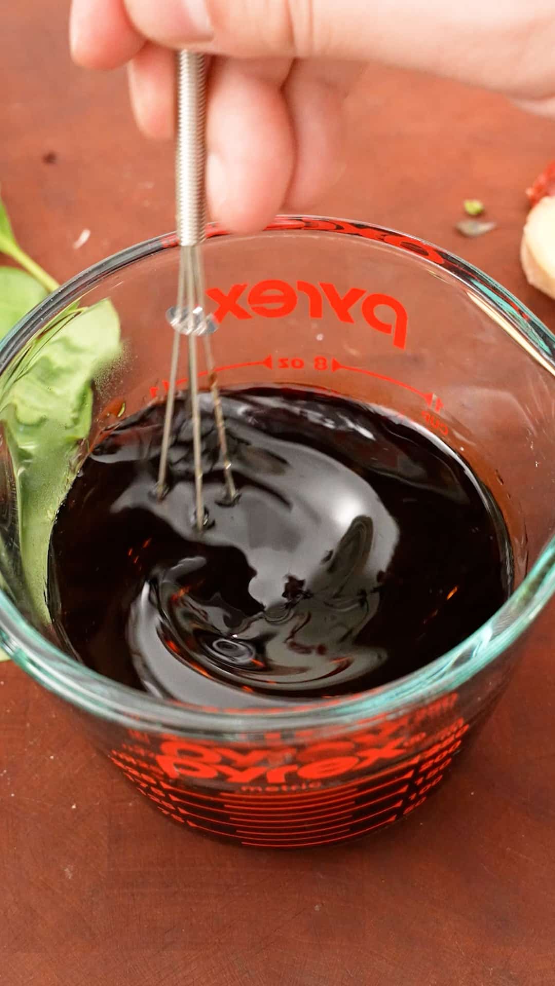 Mixing sauce in a measuring cup for Three Cup Chicken.