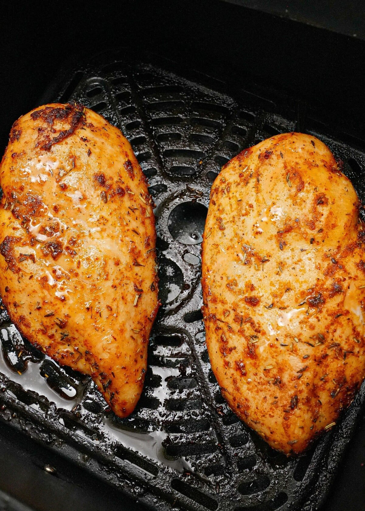 Two chicken breasts cooked in the air fryer.