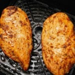 Two chicken breasts cooked in the air fryer.