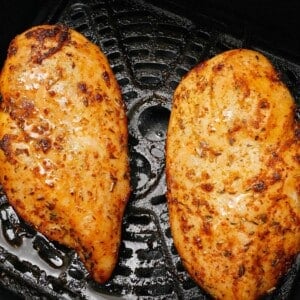 Two chicken breasts cooked in the air fryer.