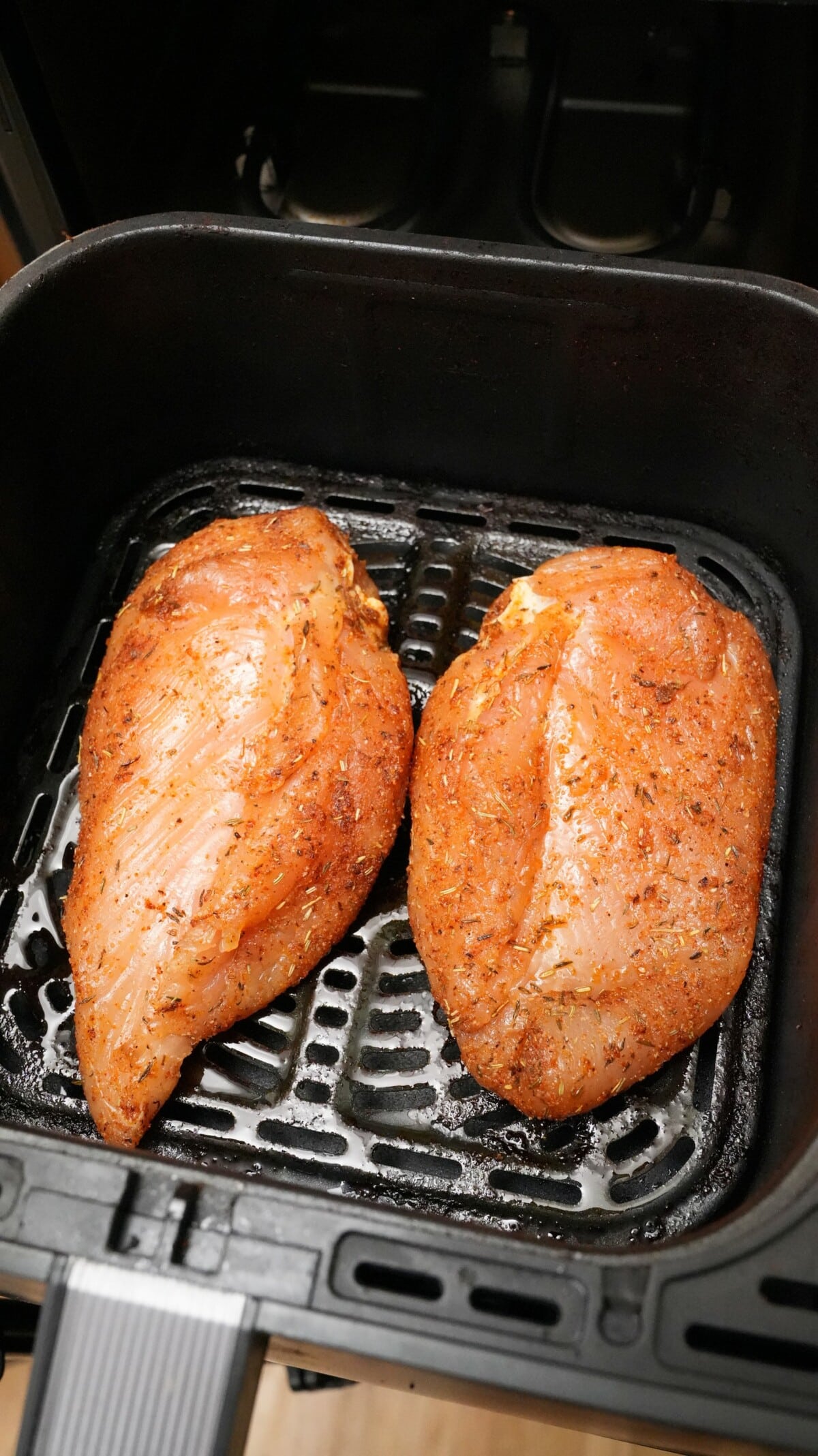 Raw chicken breasts ready to be cooked in the air fryer.