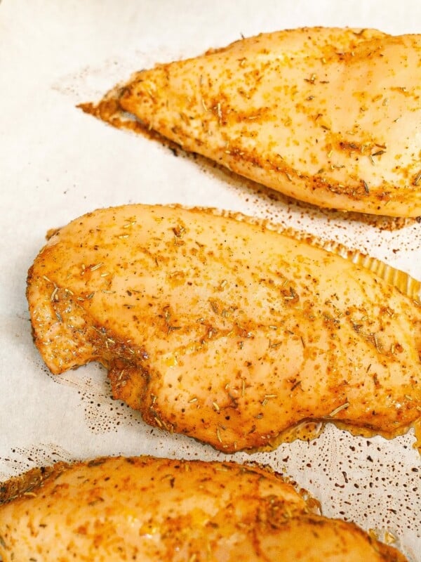 Baked chicken breasts cooked on a tray.