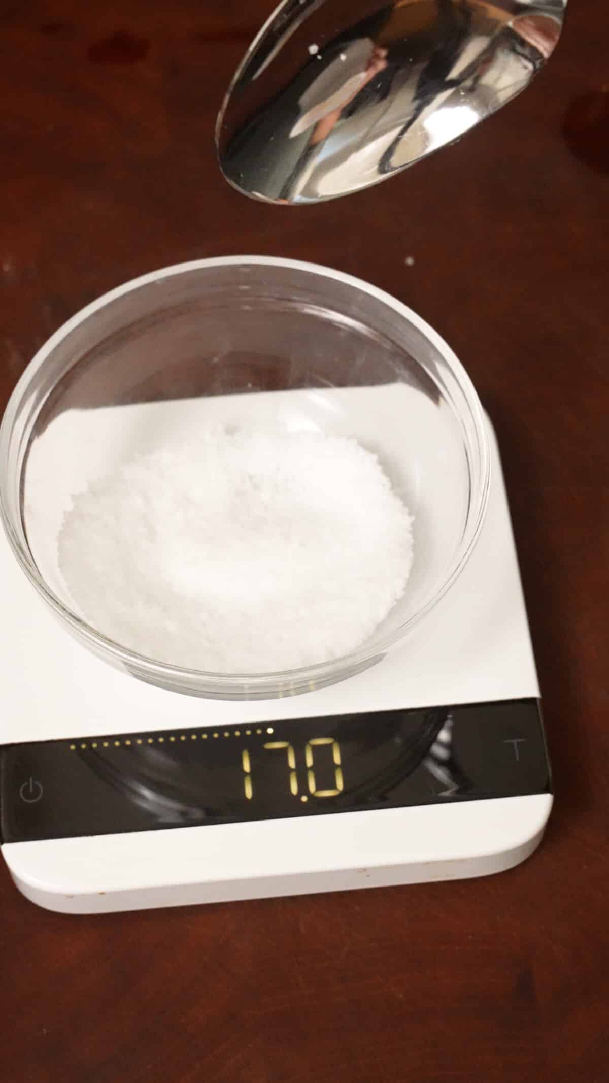 A scale showing 17 grams of kosher salt in a bowl.