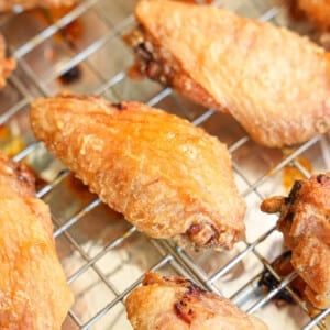 Crispy baked chicken wings resting on a wire rack.