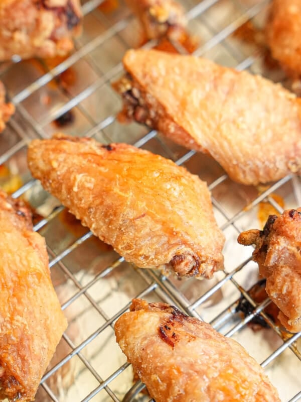 Crispy baked chicken wings resting on a wire rack.