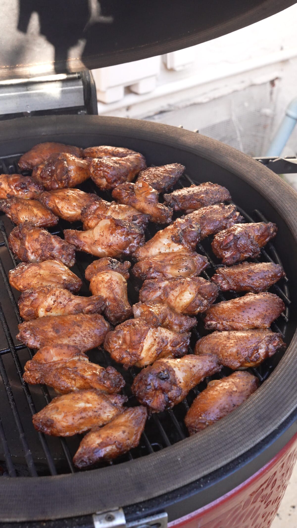 Cooked chicken wings on the indirect side of the grill.