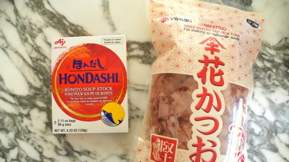 Hondashi powder next to a bag of bonito flakes.