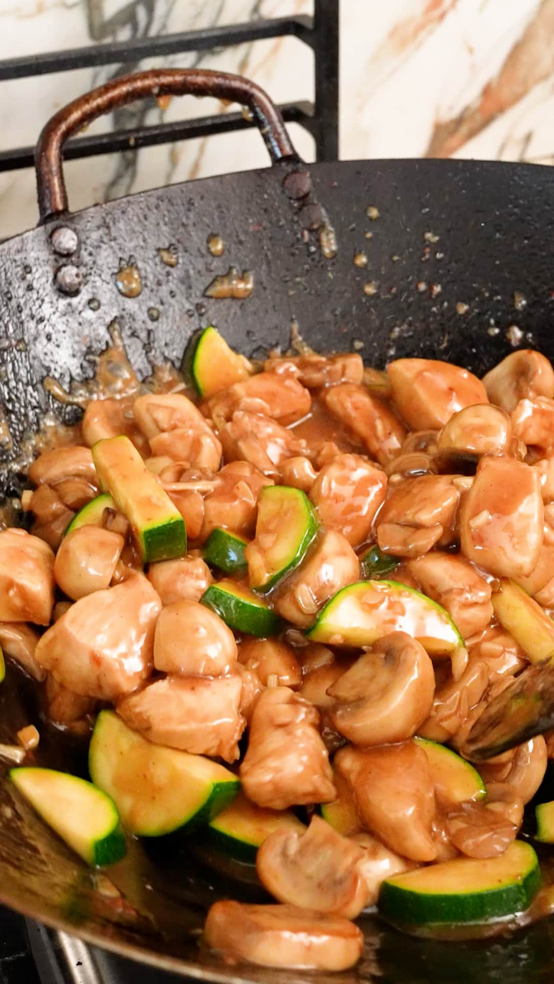 Mushroom chicken cooked in a wok.