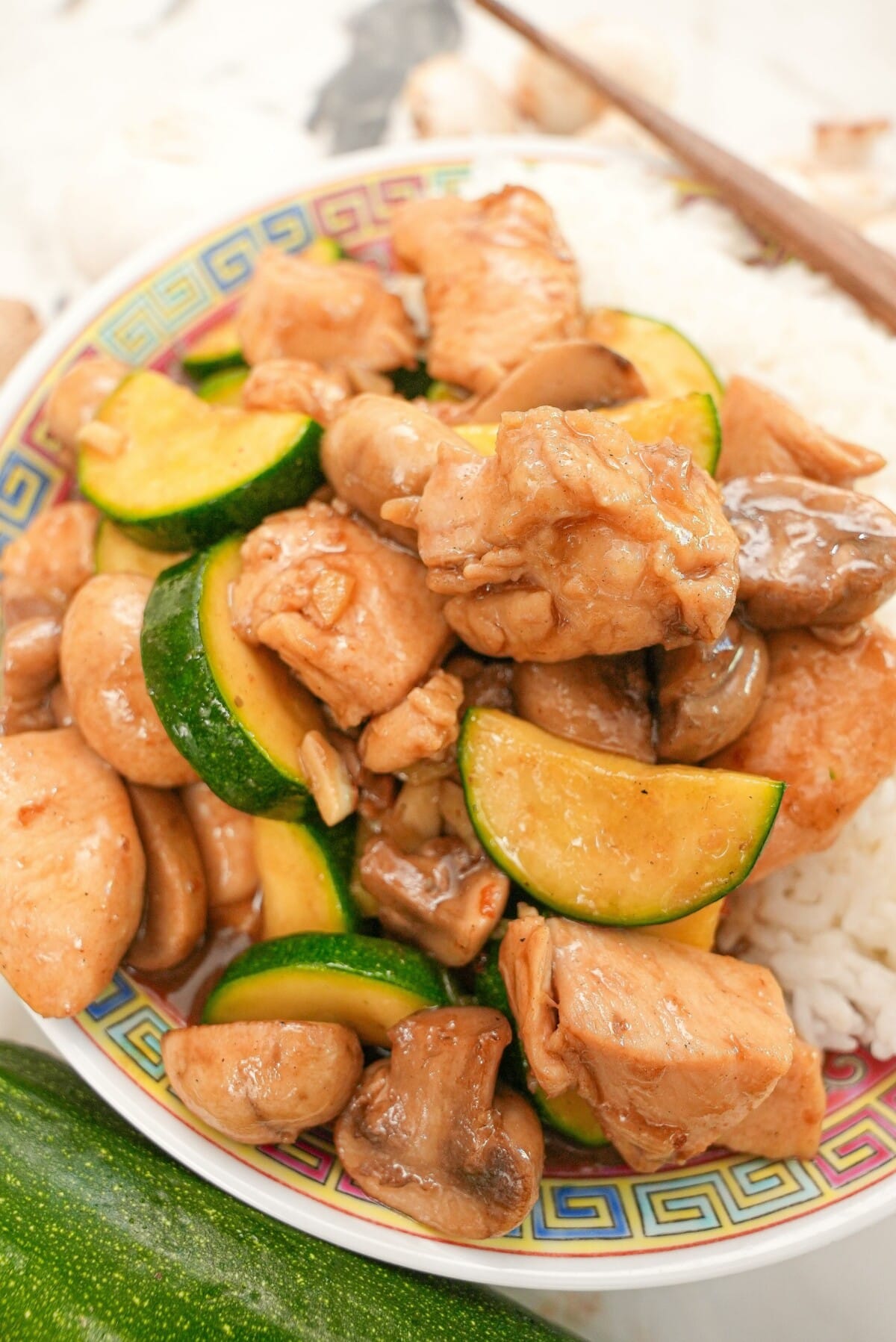 Mushroom chicken on a plate with rice.