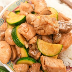 Mushroom chicken on a plate with rice.