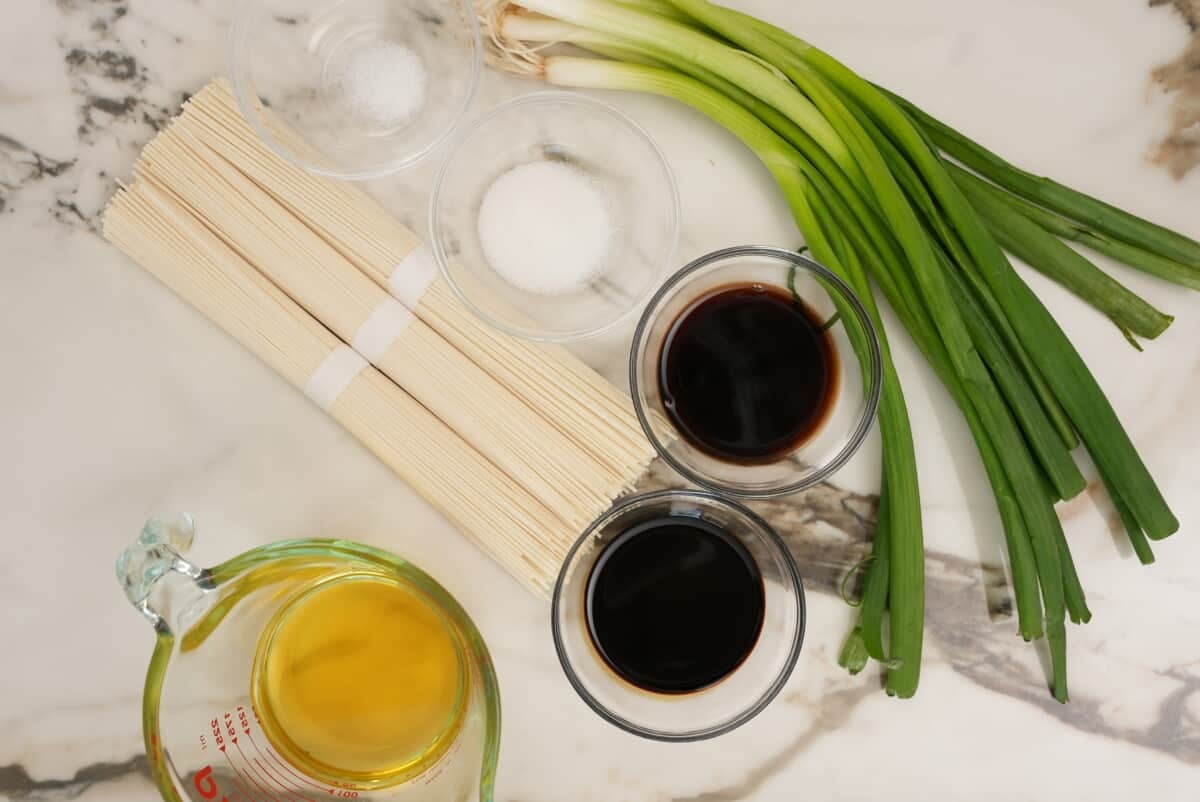 Raw ingredients for scallion oil noodles on a table.