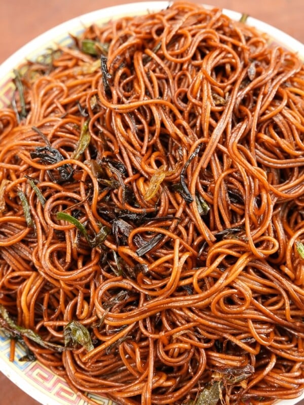 Scallion oil noodles cooked on a white plate.