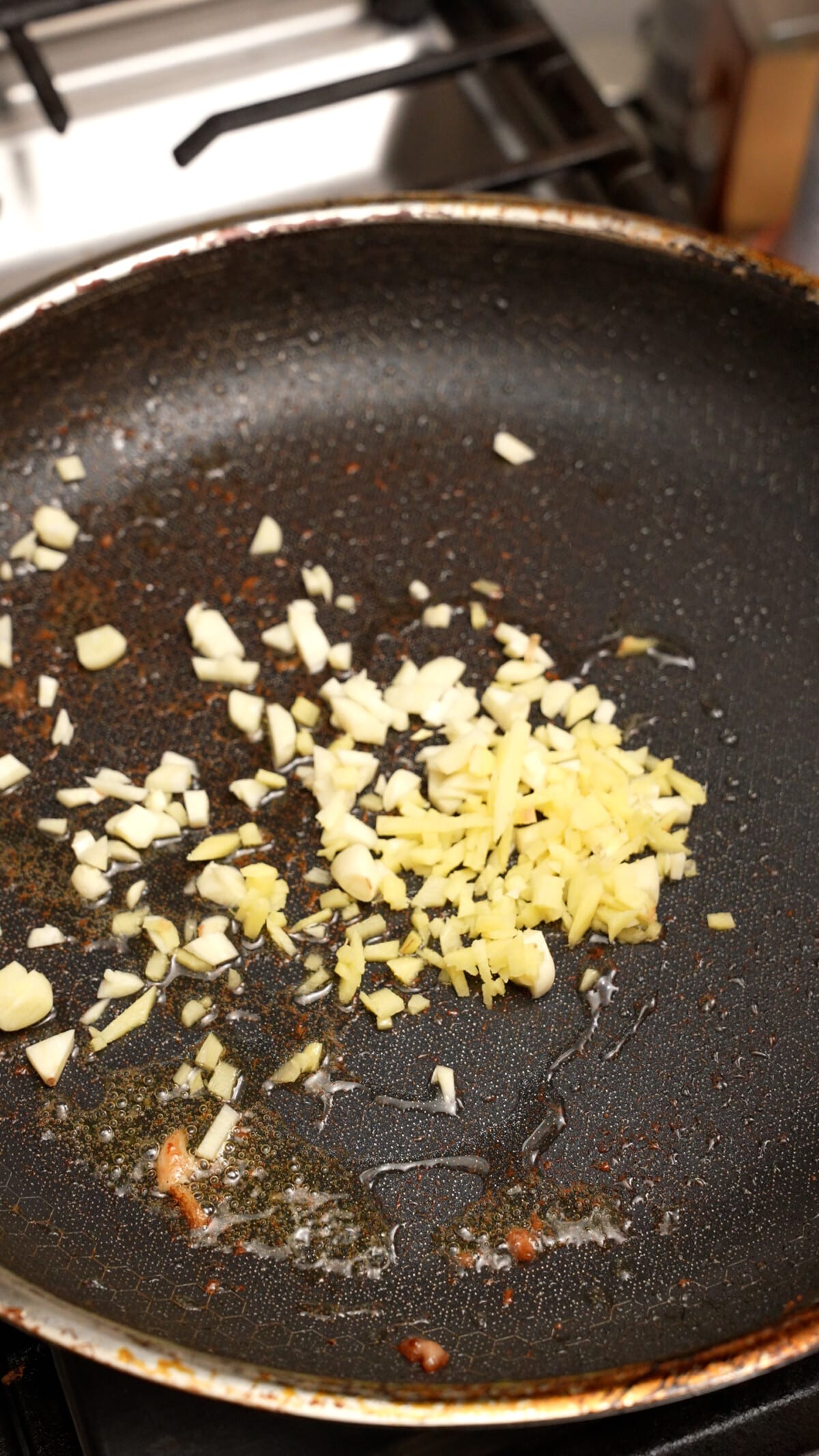 Garlic and ginger stir frying in a pan.