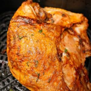 A turkey breast cooked in the air fryer with crispy golden brown skin and juicy meat.