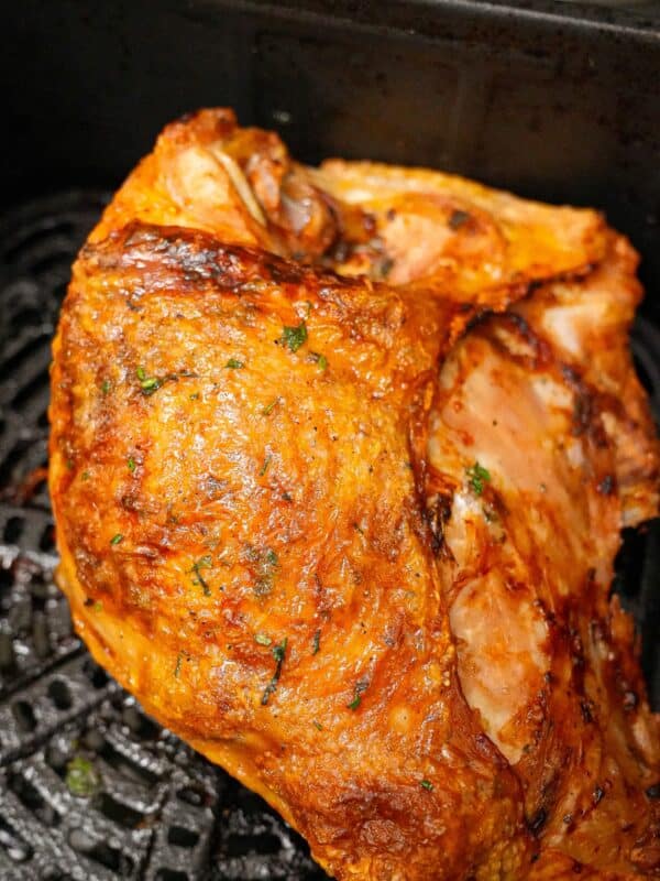 A turkey breast cooked in the air fryer with crispy golden brown skin and juicy meat.