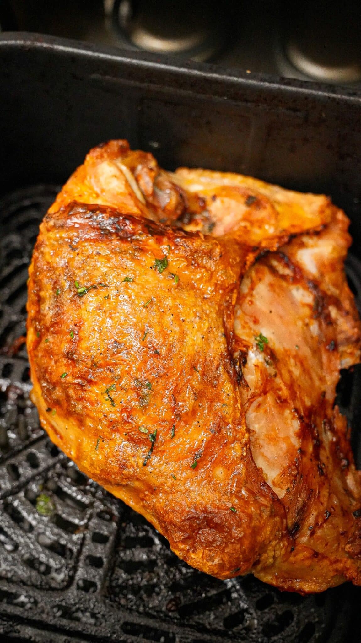 A turkey breast cooked in the air fryer with crispy golden brown skin and juicy meat.