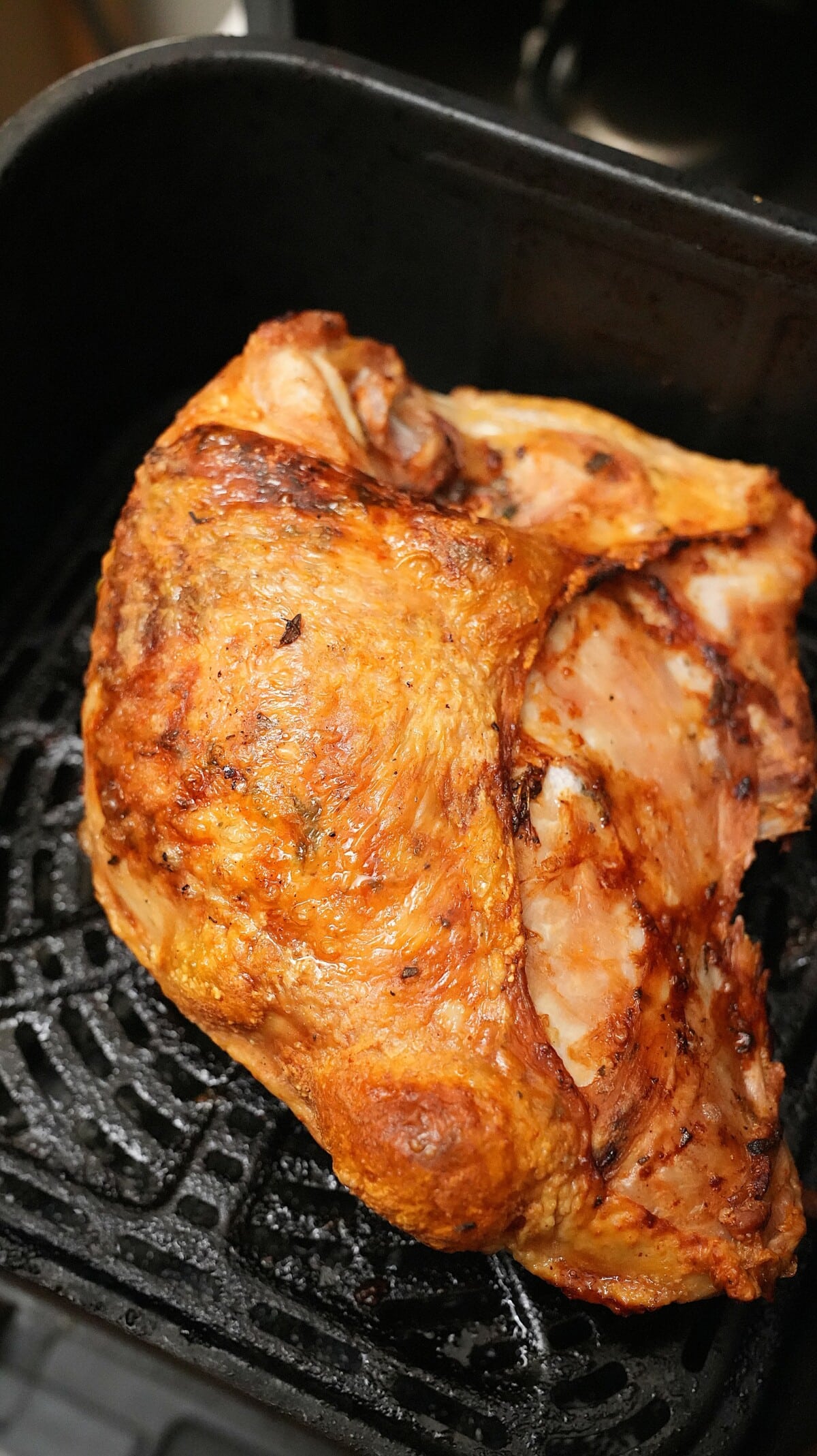 A cooked turkey breast in the air fryer.