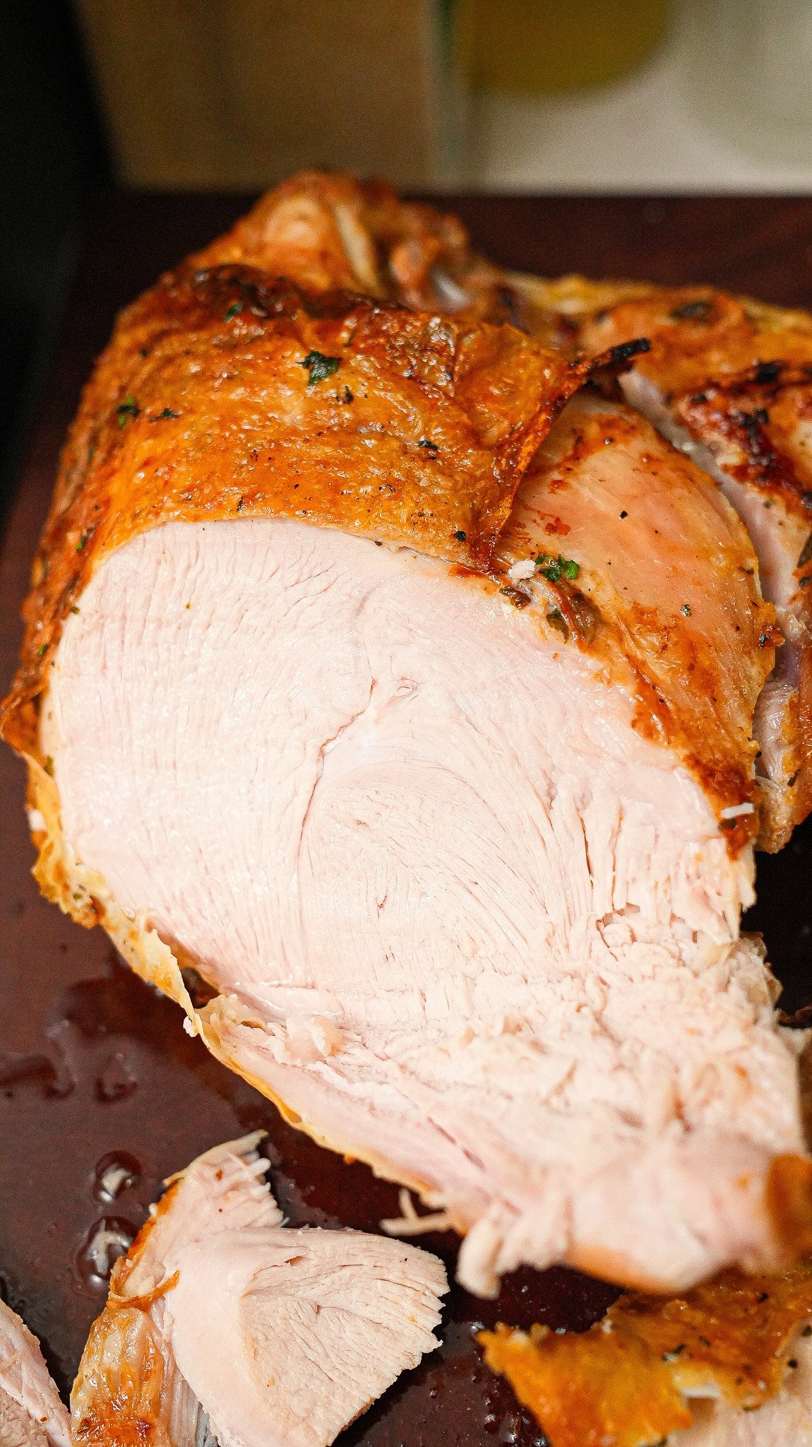 Sliced air fryer turkey breast on a cutting board.