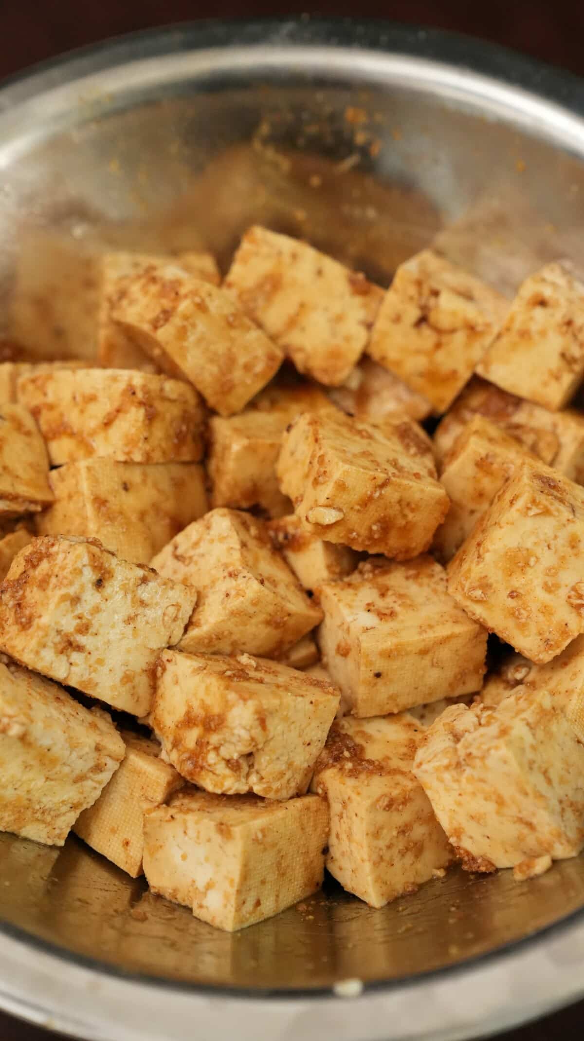 Tofu cubes seasoned in a bowl.