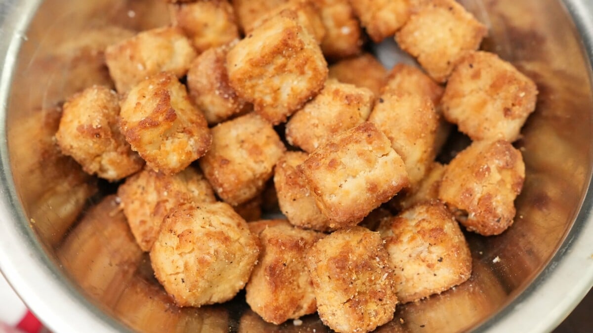 Crispy air fryer tofu cubes in a metal bowl.