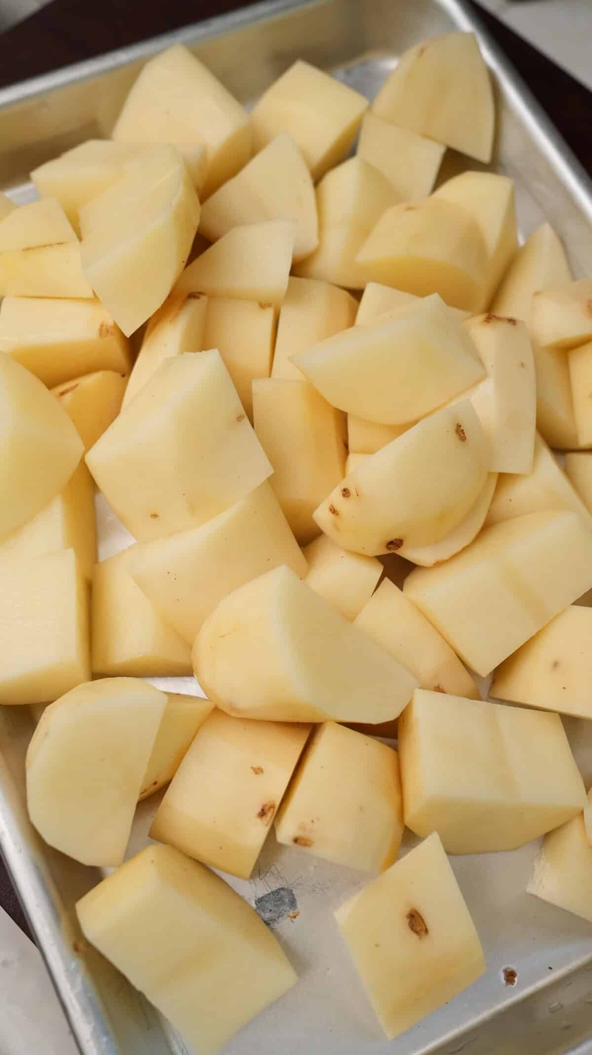 Raw potatoes cut into two inch chunks.