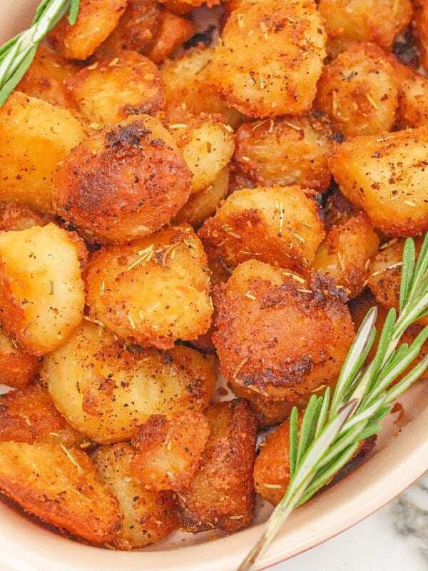 Roasted potatoes in a serving dish.