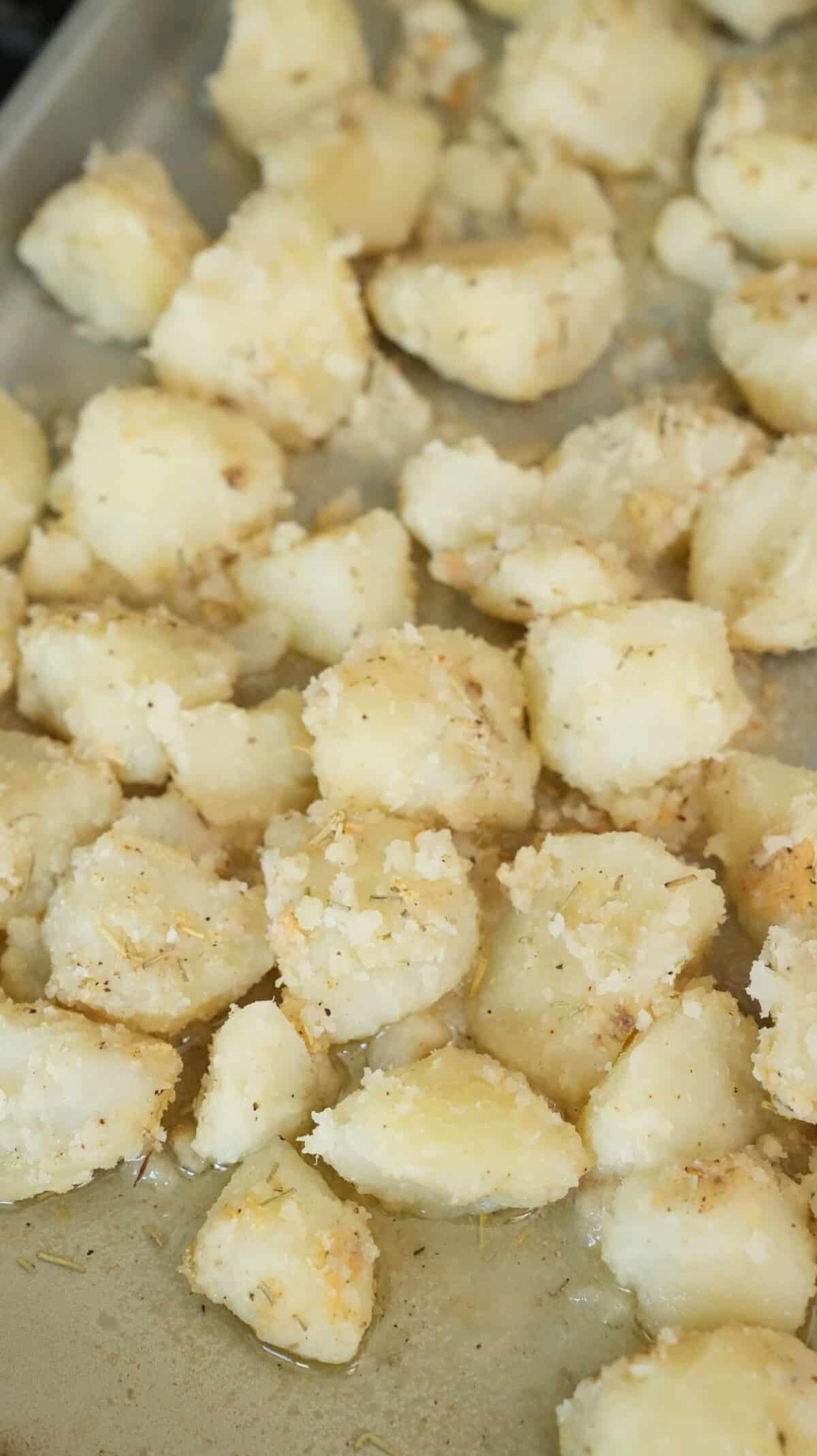 Seasoned potatoes on a baking sheet.