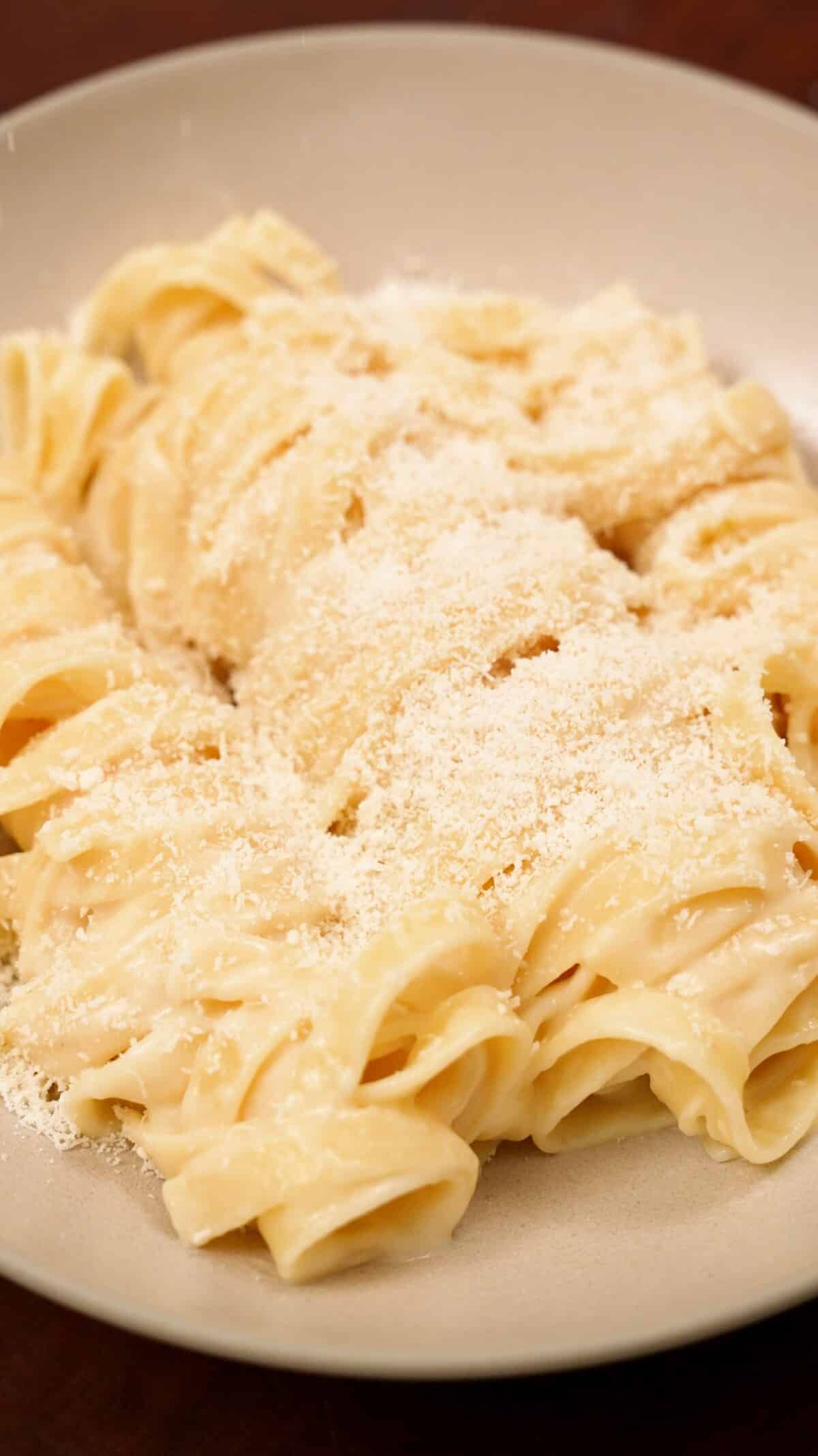 Fettuccine Alfredo plated in a bowl.