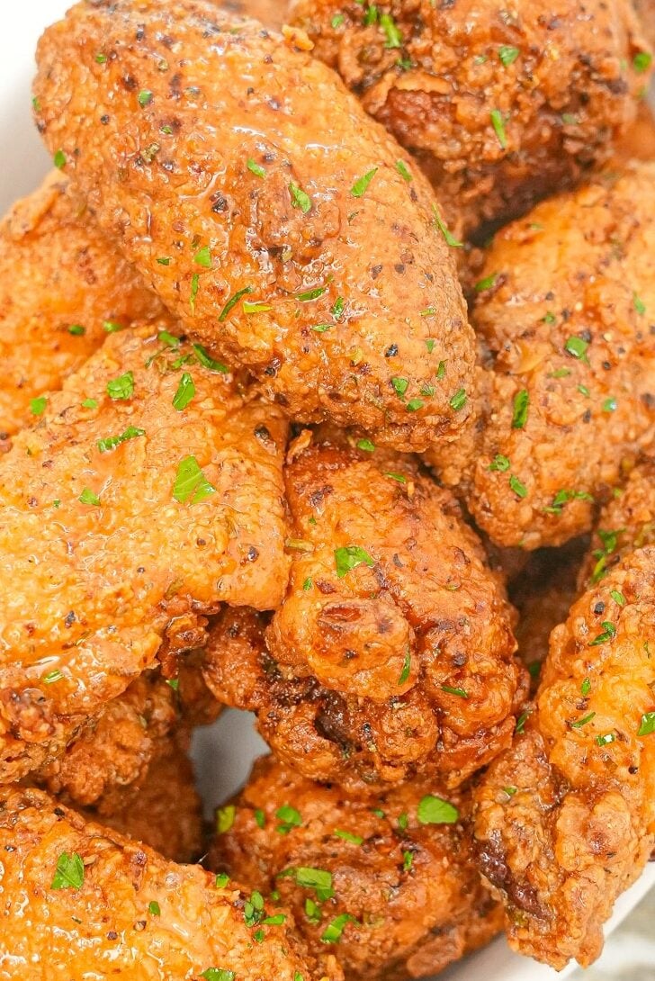 Lemon Pepper Chicken Wings stacked on a tray.