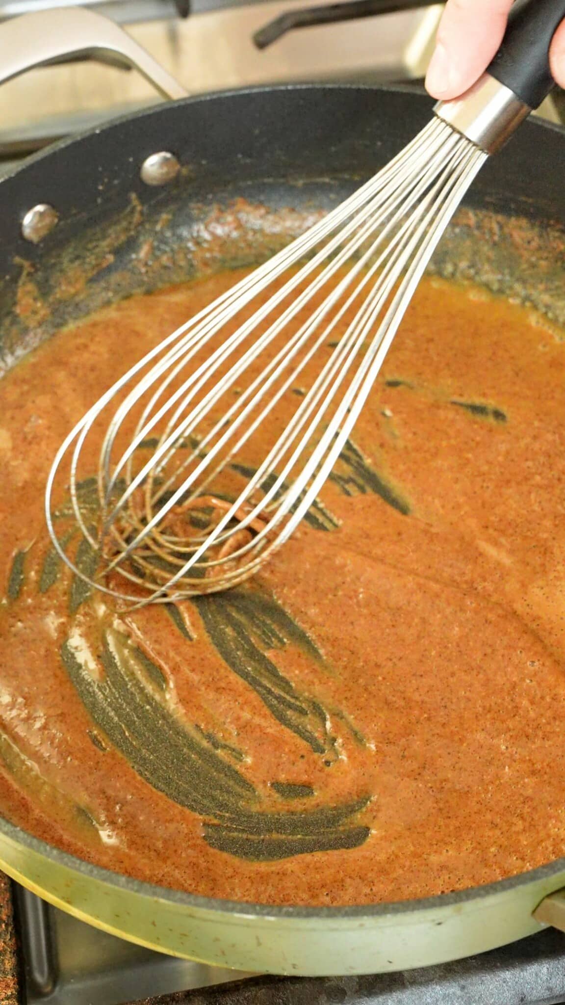 Whisking roux with flour.