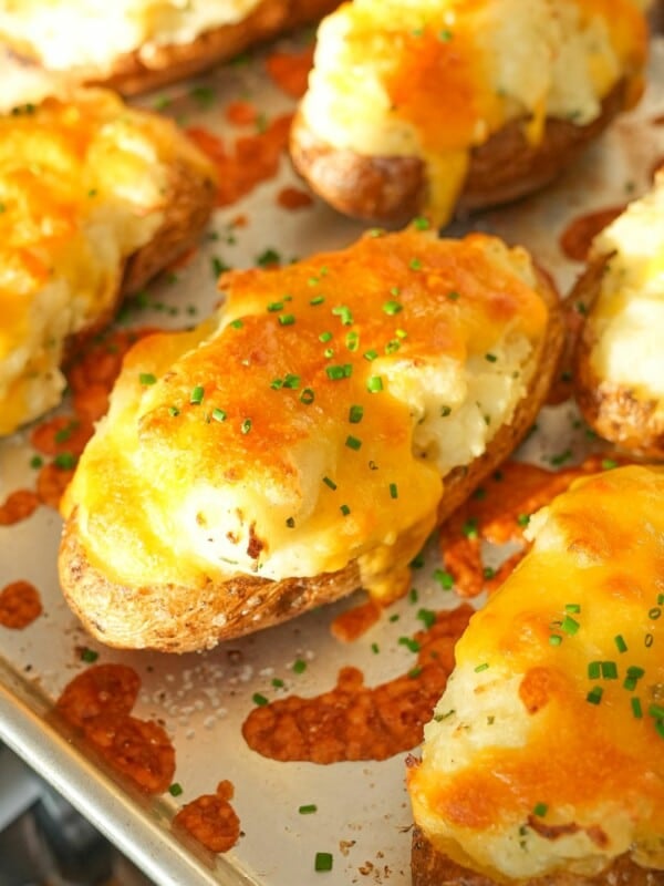 Twice Baked Potatoes on a baking sheet topped with chives.