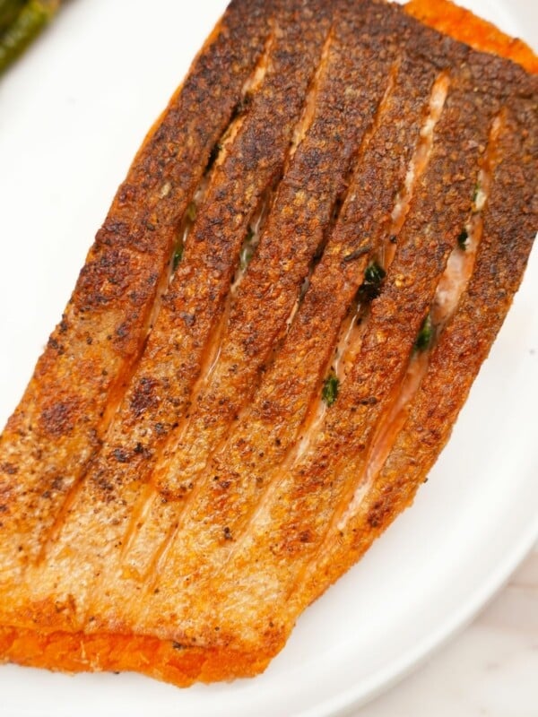 Pan seared salmon filet with crispy skin on a plate.