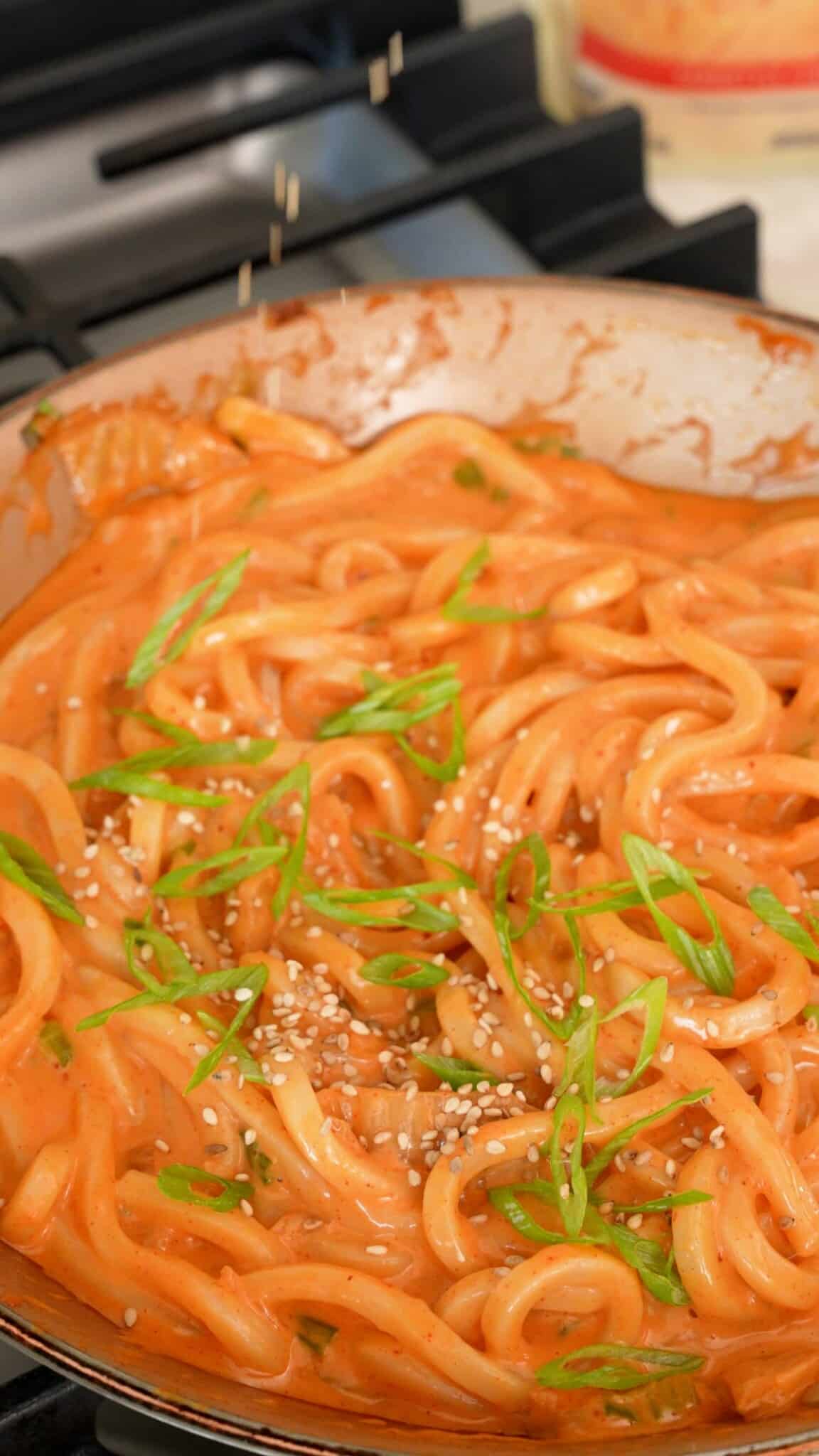 Cheesy Kimchi Udon cooked in a pan.