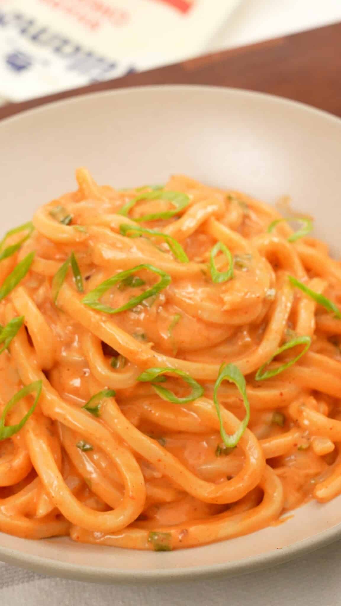 Cheesy Kimchi Udon in a bowl.