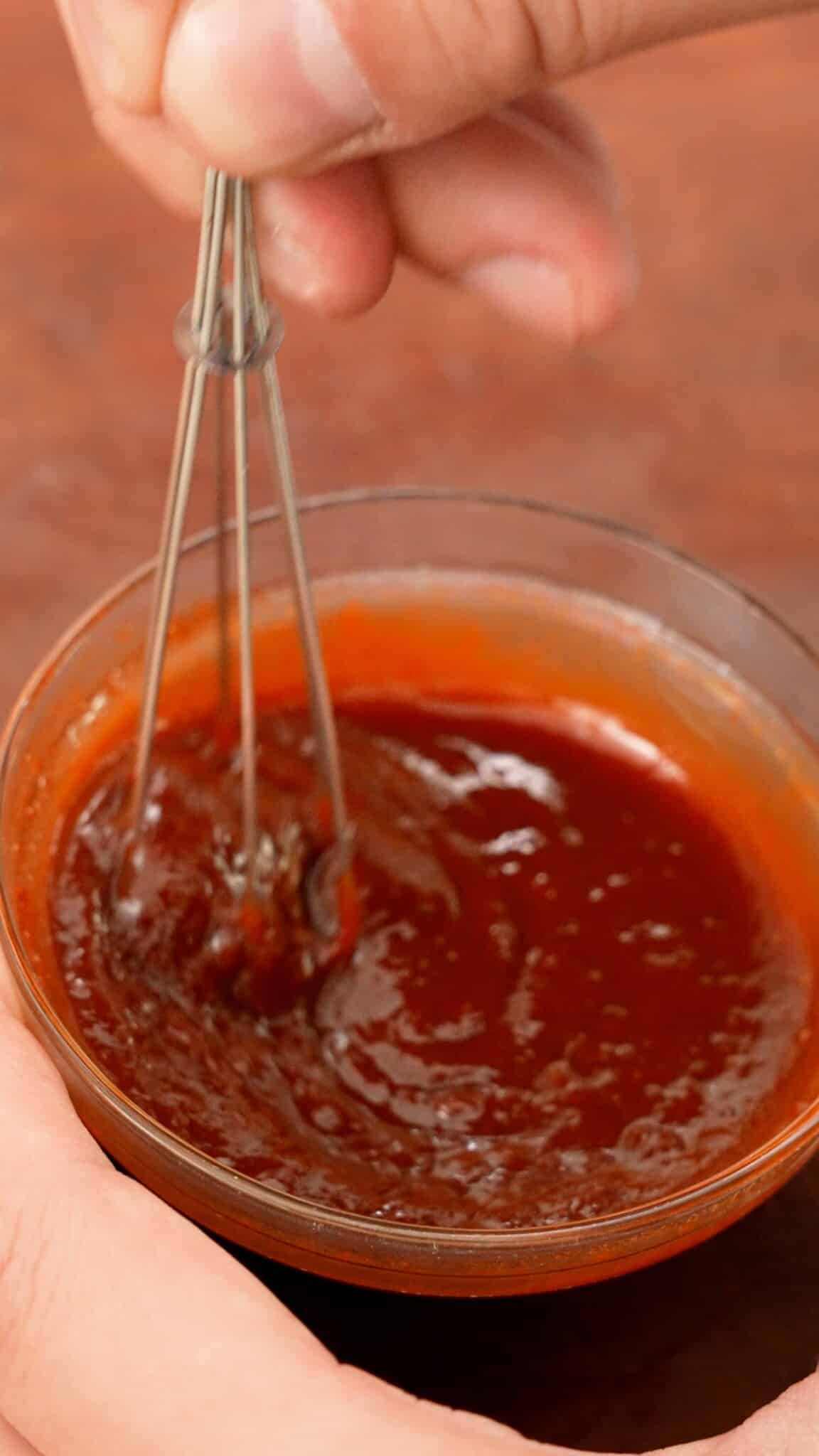 Mixing together gochujang sauce for Cheesy Kimchi Udon.