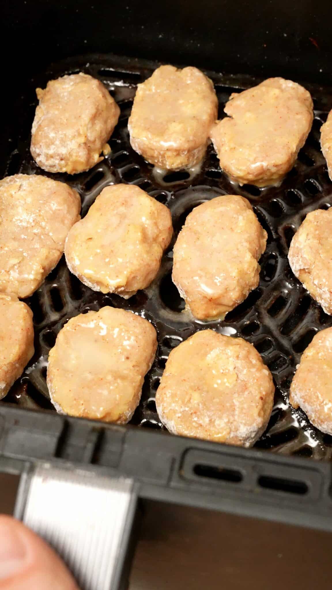 Air fryer chicken nuggets in an air fryer basket.