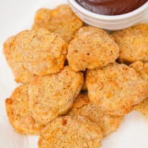 Air Fryer Chicken Nuggets on a plate with barbecue sauce.