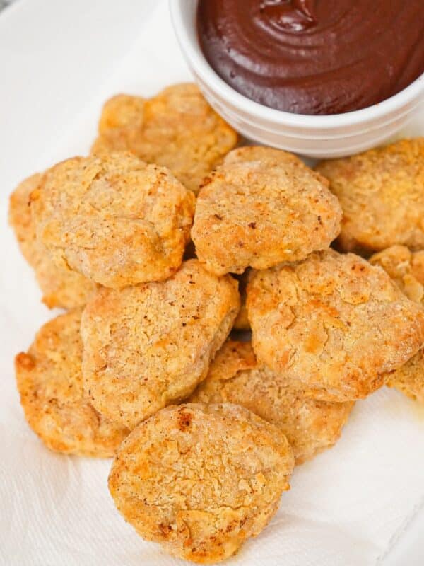 Air Fryer Chicken Nuggets on a plate with barbecue sauce.