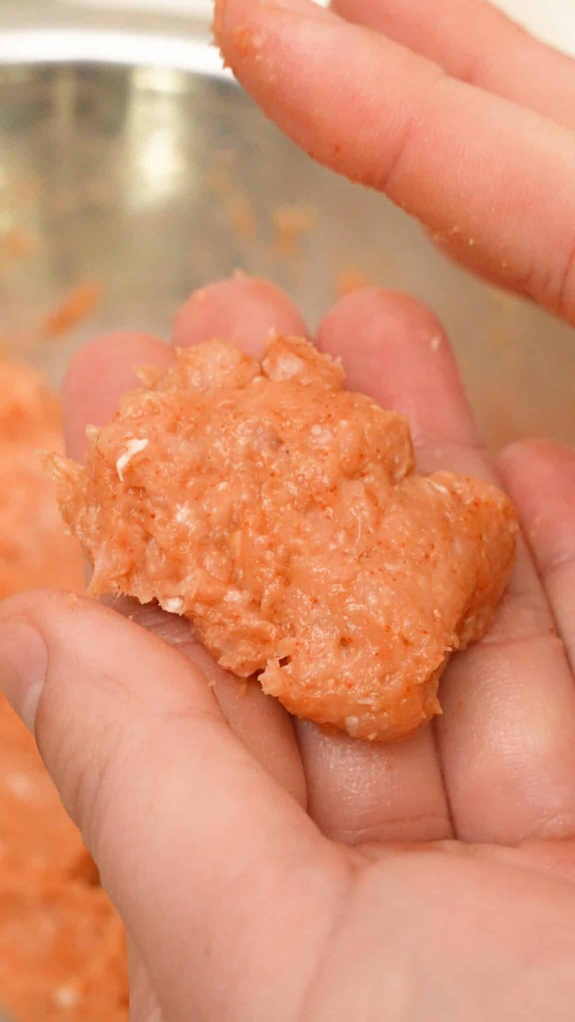 A chicken nugget shaped with a pair of hands.