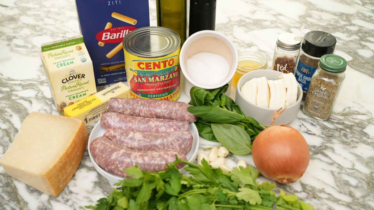 Raw ingredients for Baked Ziti on a table.