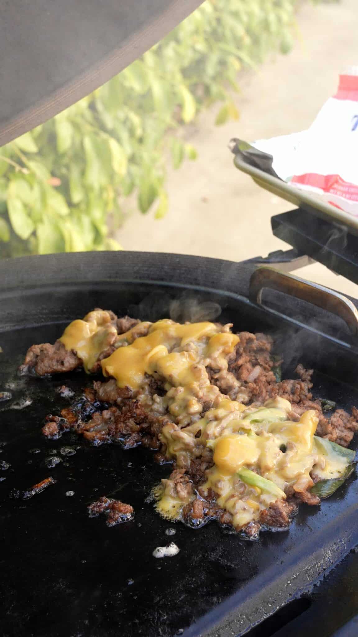 Melted cheddar cheese on grilled bulgogi meat.