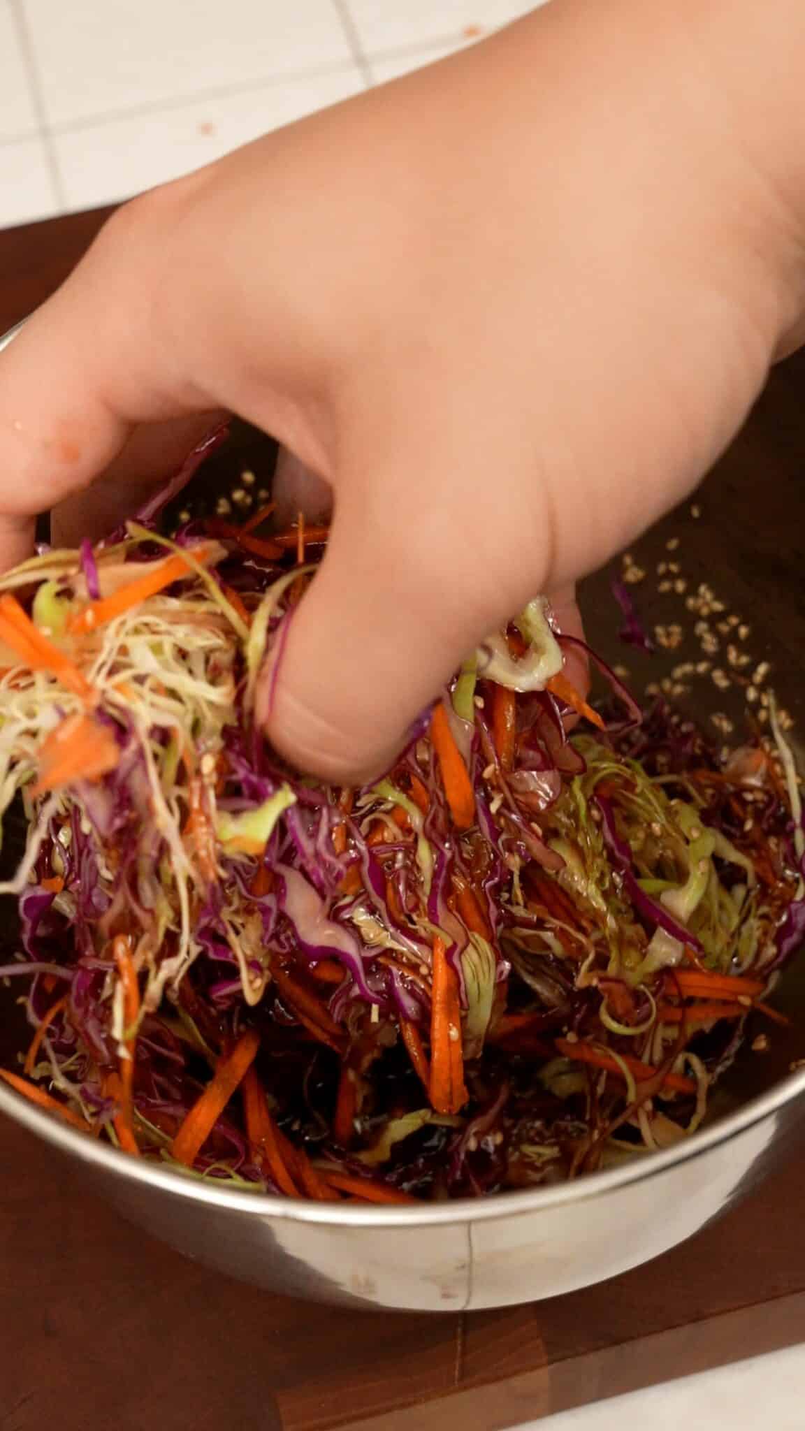 Mxiing cabbage slaw for chicken katsu sliders.